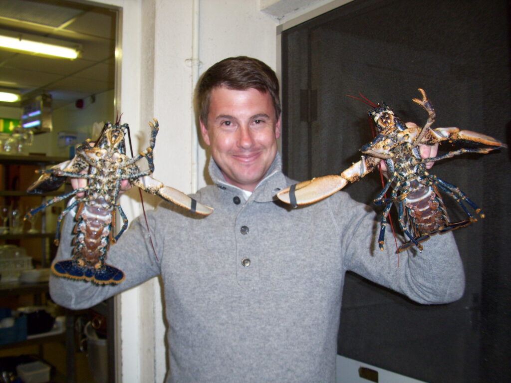 Tom at King Sitric in Howth holding lobsters